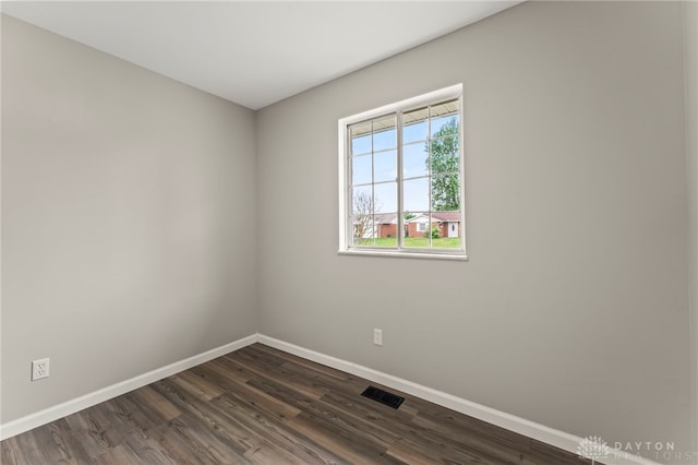 1927 Vermont Dr, Xenia, OH 45385 - empty room featuring baseboards and dark wood-type flooring