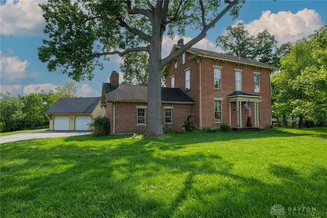 3149 W State Route 73, Wilmington, OH 45177 - view of front of house featuring a chimney, brick siding, concrete driveway, and a garage