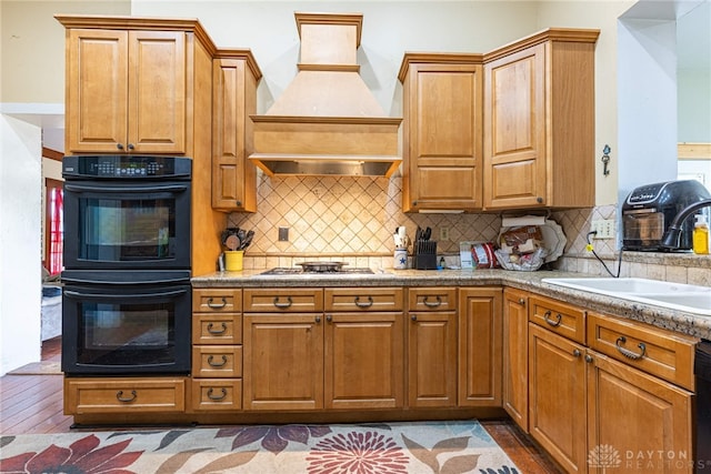 3149 W State Route 73, Wilmington, OH 45177 - kitchen featuring premium range hood, stainless steel gas stovetop, hardwood / wood-style flooring, and tasteful backsplash
