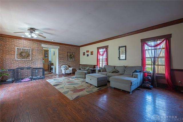 3149 W State Route 73, Wilmington, OH 45177 - living room with wood finished floors, healthy amount of natural light, a ceiling fan, crown molding, and brick wall
