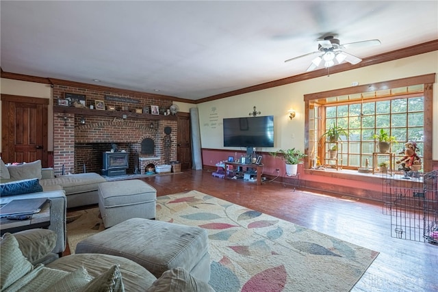3149 W State Route 73, Wilmington, OH 45177 - living room featuring wood finished floors, a ceiling fan, a wood stove, and crown molding