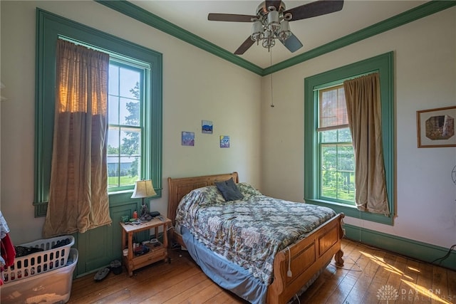 3149 W State Route 73, Wilmington, OH 45177 - bedroom featuring multiple windows, wood-type flooring, crown molding, and a ceiling fan