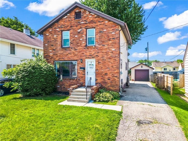 1707 Maiden Ln, Springfield, OH 45504 - view of front facade with driveway, brick siding, a garage, and an outbuilding