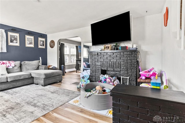 1707 Maiden Ln, Springfield, OH 45504 - living room with a fireplace, wood finished floors, and arched walkways