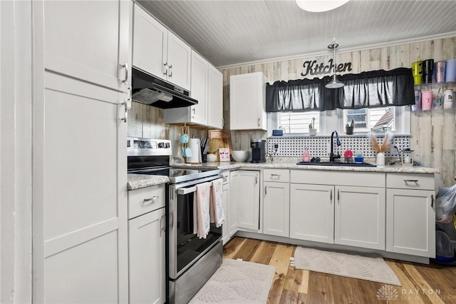 1707 Maiden Ln, Springfield, OH 45504 - kitchen featuring stainless steel range with electric stovetop, under cabinet range hood, white cabinetry, light wood-style floors, and light stone counters