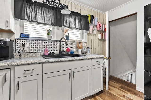 1707 Maiden Ln, Springfield, OH 45504 - kitchen with tasteful backsplash, wood finished floors, crown molding, white cabinetry, and light stone countertops