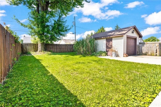 1707 Maiden Ln, Springfield, OH 45504 - fenced backyard featuring an outbuilding, a detached garage, and driveway