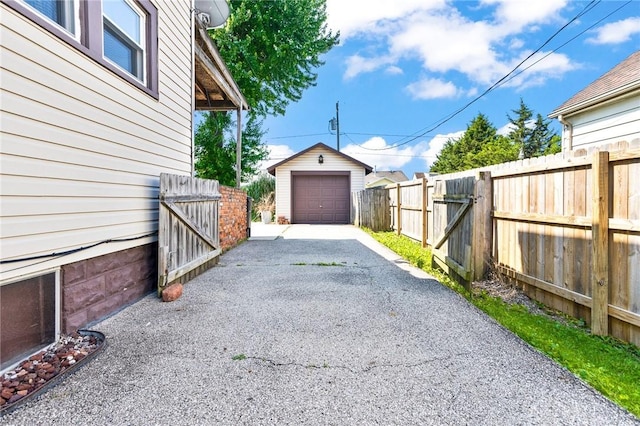 1707 Maiden Ln, Springfield, OH 45504 - view of parking / parking lot featuring a gate, driveway, and a garage