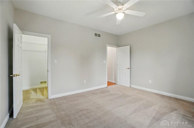 3862 Robinson Vail Rd, Franklin, OH 45005 - unfurnished bedroom featuring light carpet, a walk in closet, and ceiling fan