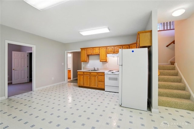 3862 Robinson Vail Rd, Franklin, OH 45005 - kitchen with white appliances, under cabinet range hood, light countertops, and brown cabinets