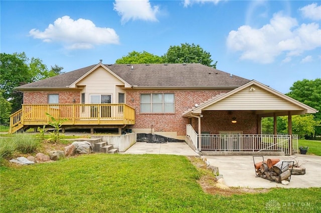 3862 Robinson Vail Rd, Franklin, OH 45005 - back of house with a patio area, an outdoor fire pit, brick siding, a wooden deck, and a yard