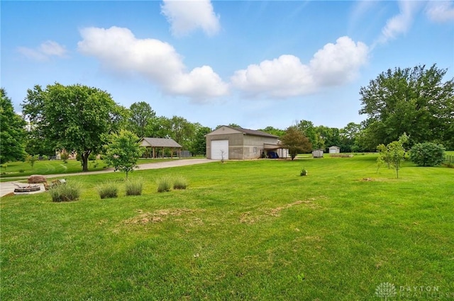 3862 Robinson Vail Rd, Franklin, OH 45005 - view of grassy yard featuring a detached garage, concrete driveway, and an outbuilding