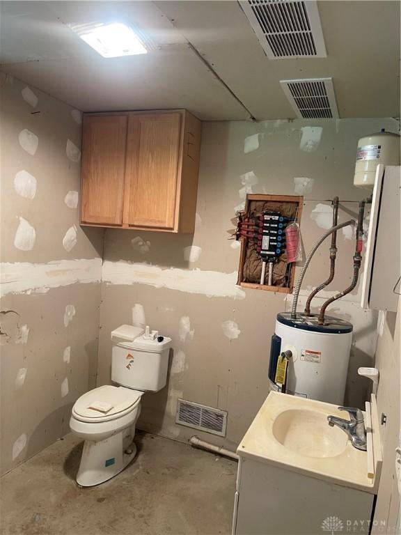 3862 Robinson Vail Rd, Franklin, OH 45005 - bathroom featuring water heater, concrete floors, and vanity