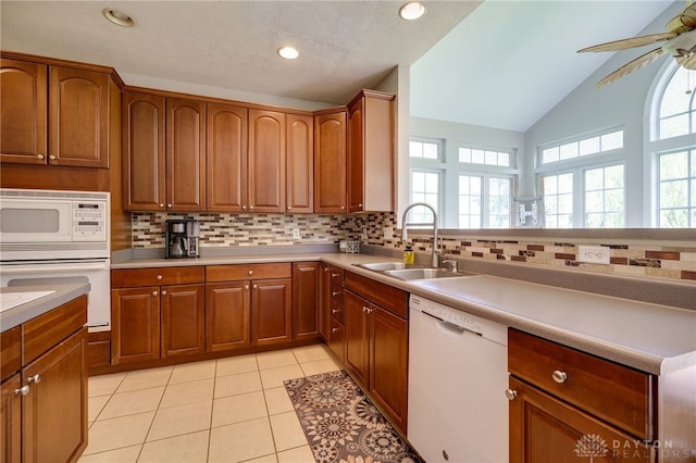 3334 Greycliff Trl, Franklin Twp, OH 45005 - kitchen featuring white appliances, decorative backsplash, brown cabinets, vaulted ceiling, and recessed lighting