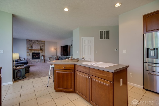 3334 Greycliff Trl, Franklin Twp, OH 45005 - kitchen with stainless steel fridge with ice dispenser, light tile patterned floors, a fireplace, open floor plan, and recessed lighting