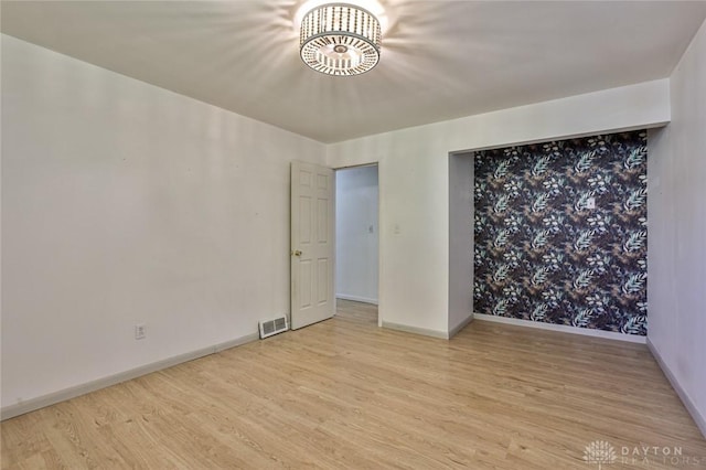 4108 Central Ave, Middletown, OH 45044 - empty room featuring wood finished floors and a chandelier