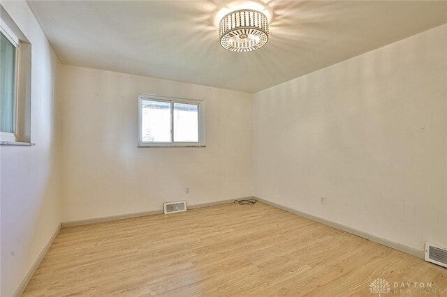 4108 Central Ave, Middletown, OH 45044 - spare room with wood finished floors and a chandelier