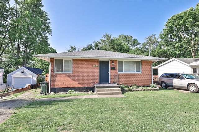 4108 Central Ave, Middletown, OH 45044 - bungalow featuring an outbuilding, a front lawn, brick siding, and a garage