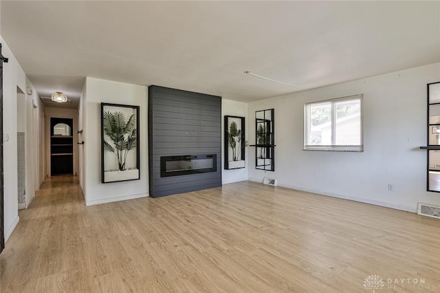4108 Central Ave, Middletown, OH 45044 - unfurnished living room featuring light wood-style floors and a large fireplace