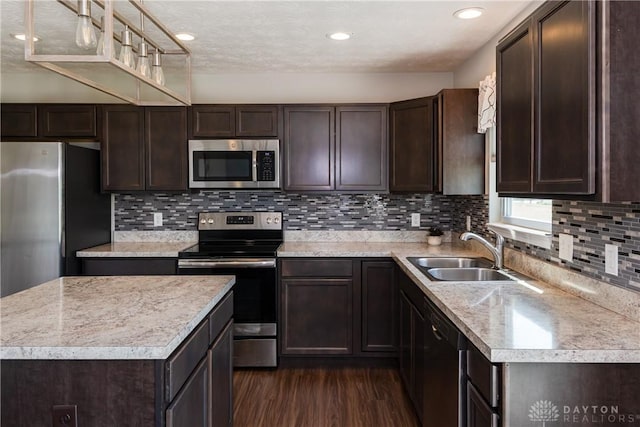 133 Followers Way, Waynesville, OH 45068 - kitchen with stainless steel appliances, dark brown cabinets, dark wood-style flooring, light countertops, and tasteful backsplash