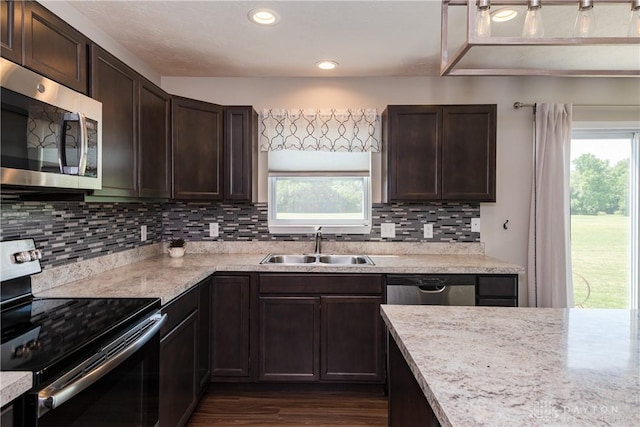 133 Followers Way, Waynesville, OH 45068 - kitchen featuring appliances with stainless steel finishes, dark brown cabinets, dark wood-type flooring, decorative backsplash, and recessed lighting