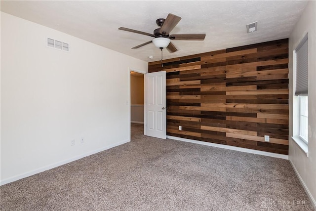 133 Followers Way, Waynesville, OH 45068 - unfurnished room featuring wooden walls, carpet flooring, and ceiling fan