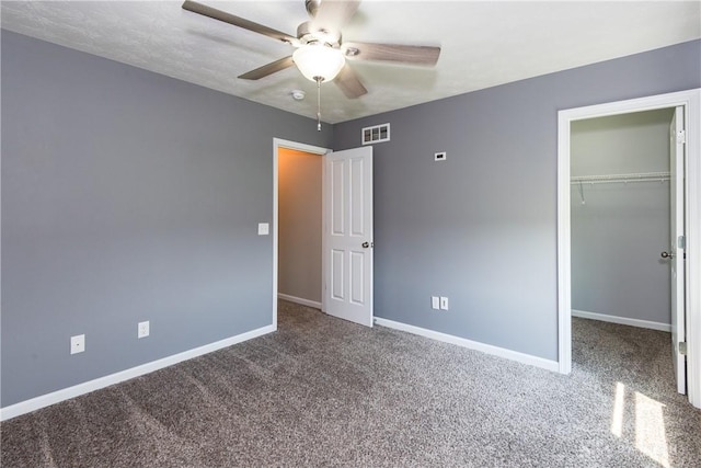 133 Followers Way, Waynesville, OH 45068 - unfurnished bedroom featuring carpet floors, a walk in closet, a closet, and a ceiling fan