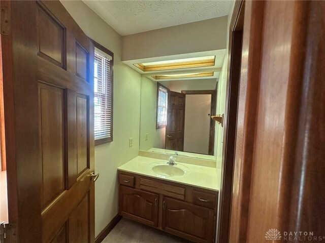 6553 Stillcrest Way, Dayton, OH 45414 - bathroom with vanity and a textured ceiling