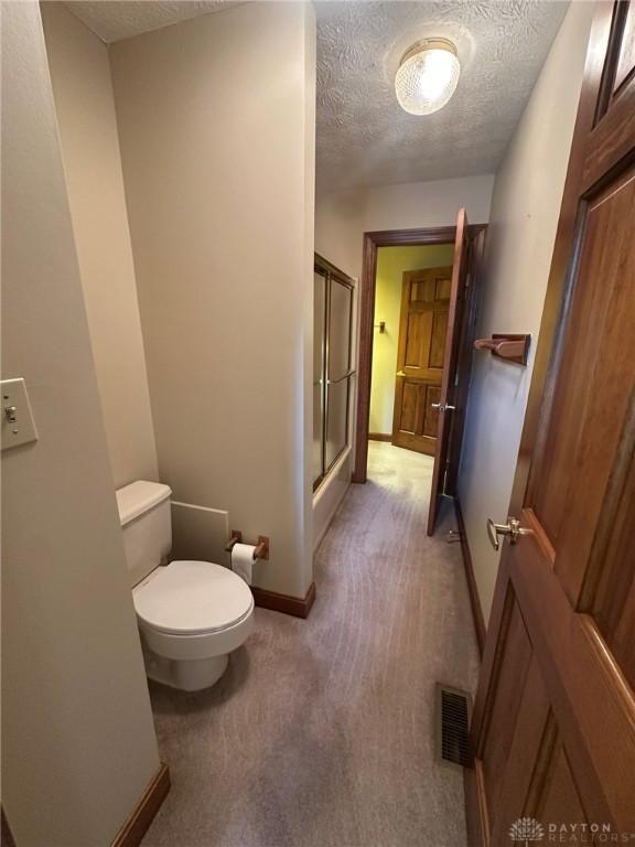 6553 Stillcrest Way, Dayton, OH 45414 - bathroom with a textured ceiling and a shower stall