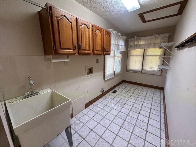 6553 Stillcrest Way, Dayton, OH 45414 - laundry room with hookup for a washing machine, cabinet space, light tile patterned flooring, electric dryer hookup, and a textured ceiling