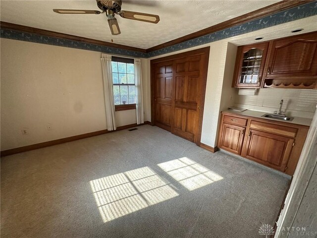 6553 Stillcrest Way, Dayton, OH 45414 - unfurnished bedroom featuring light colored carpet, crown molding, a ceiling fan, a closet, and a textured ceiling