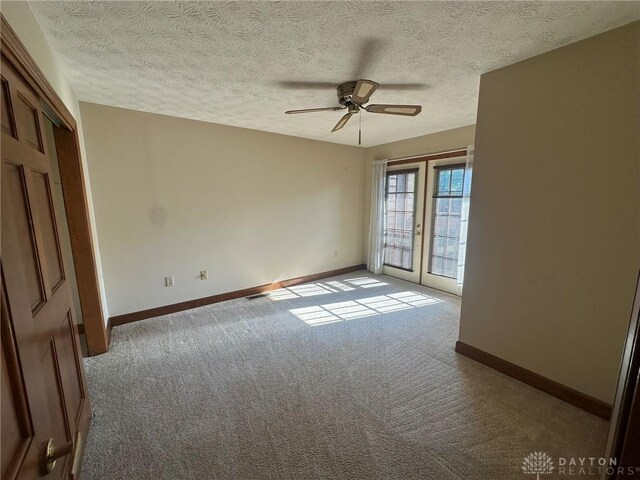 6553 Stillcrest Way, Dayton, OH 45414 - carpeted empty room featuring french doors, a ceiling fan, and a textured ceiling