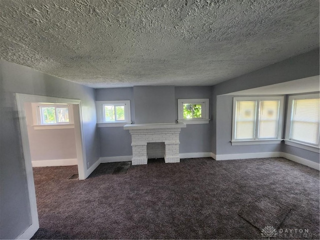 953 Five Oaks Ave Unit 943, Dayton, OH 45406 - unfurnished living room featuring carpet, a textured ceiling, and a brick fireplace