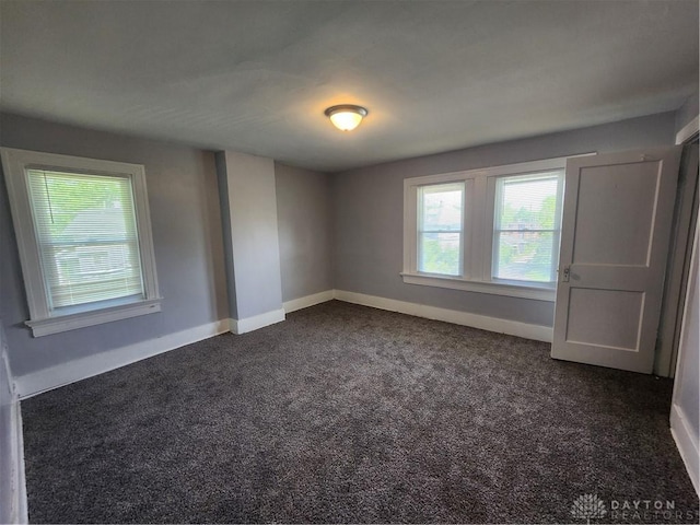 953 Five Oaks Ave Unit 943, Dayton, OH 45406 - unfurnished room featuring dark colored carpet and baseboards