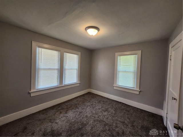 953 Five Oaks Ave Unit 943, Dayton, OH 45406 - empty room featuring dark colored carpet and baseboards