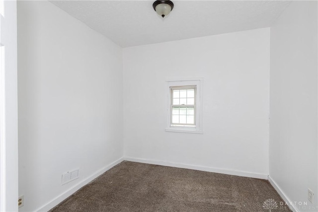 2241 E 3rd St, Dayton, OH 45403 - spare room with dark colored carpet and baseboards