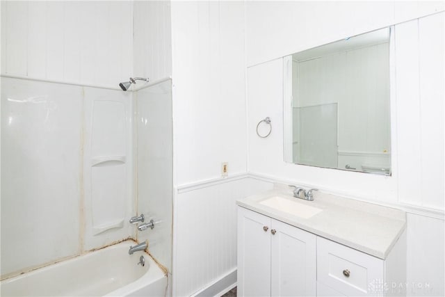 2241 E 3rd St, Dayton, OH 45403 - bathroom with vanity, bathtub / shower combination, a wainscoted wall, and a decorative wall