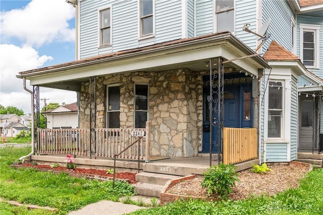 2241 E 3rd St, Dayton, OH 45403 - doorway to property featuring a porch and stone siding