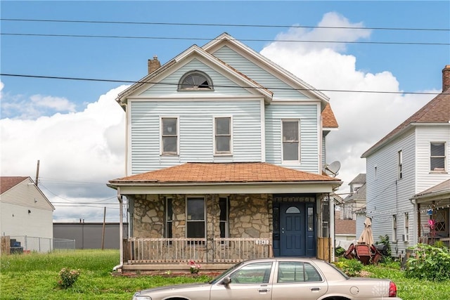 2241 E 3rd St, Dayton, OH 45403 - view of front of property with a porch, a chimney, stone siding, and roof with shingles