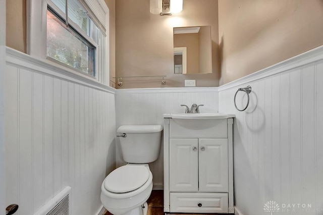 1210 Clovernook Dr, Hamilton, OH 45013 - half bathroom with wainscoting, vanity, and a decorative wall