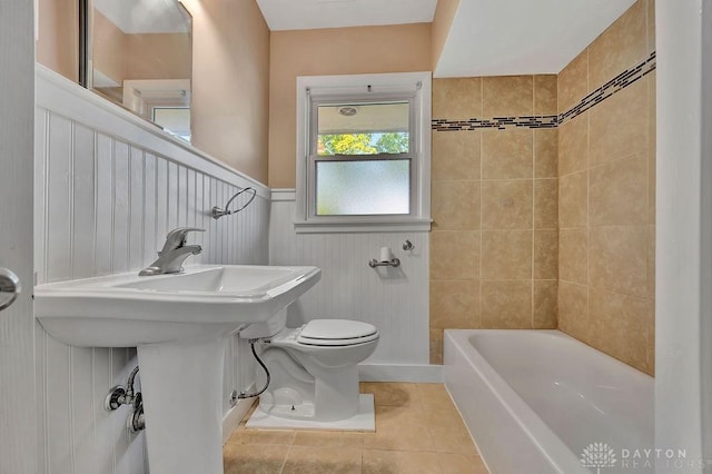 1210 Clovernook Dr, Hamilton, OH 45013 - bathroom featuring tile patterned floors, a wainscoted wall, and shower / washtub combination