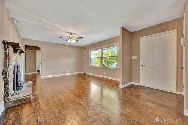 1210 Clovernook Dr, Hamilton, OH 45013 - unfurnished living room featuring a ceiling fan, arched walkways, and wood finished floors