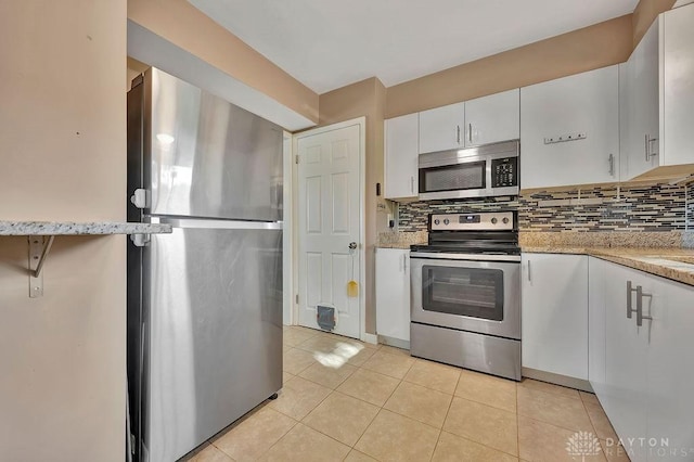 1210 Clovernook Dr, Hamilton, OH 45013 - kitchen featuring stainless steel appliances, white cabinets, backsplash, and light tile patterned floors