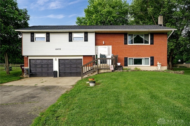 10452 S Union Rd, Miamisburg, OH 45342 - split foyer home featuring a front lawn, concrete driveway, a garage, and brick siding