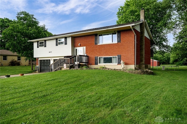 10452 S Union Rd, Miamisburg, OH 45342 - rear view of house featuring a chimney, a yard, a garage, and brick siding