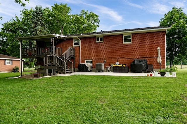 10452 S Union Rd, Miamisburg, OH 45342 - rear view of house with a patio, a lawn, stairway, a wooden deck, and brick siding