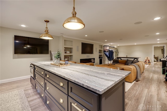 243 Woodside Trl, Clearcreek Twp, OH 45036 - kitchen with a kitchen island, pendant lighting, light wood-type flooring, recessed lighting, and light stone countertops