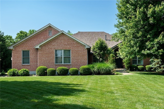 243 Woodside Trl, Clearcreek Twp, OH 45036 - view of front facade featuring a front yard, brick siding, and roof with shingles