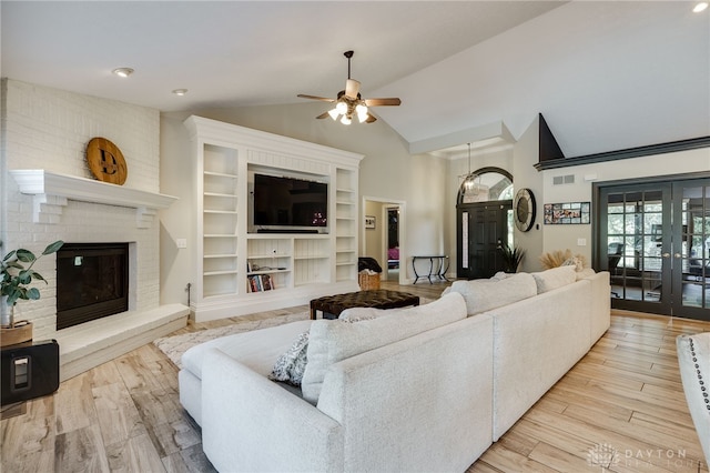 243 Woodside Trl, Clearcreek Twp, OH 45036 - living area featuring ceiling fan, lofted ceiling, french doors, wood finished floors, and a brick fireplace