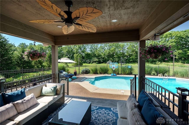 243 Woodside Trl, Clearcreek Twp, OH 45036 - view of pool with an outdoor living space, a fenced backyard, ceiling fan, and view of wooded area